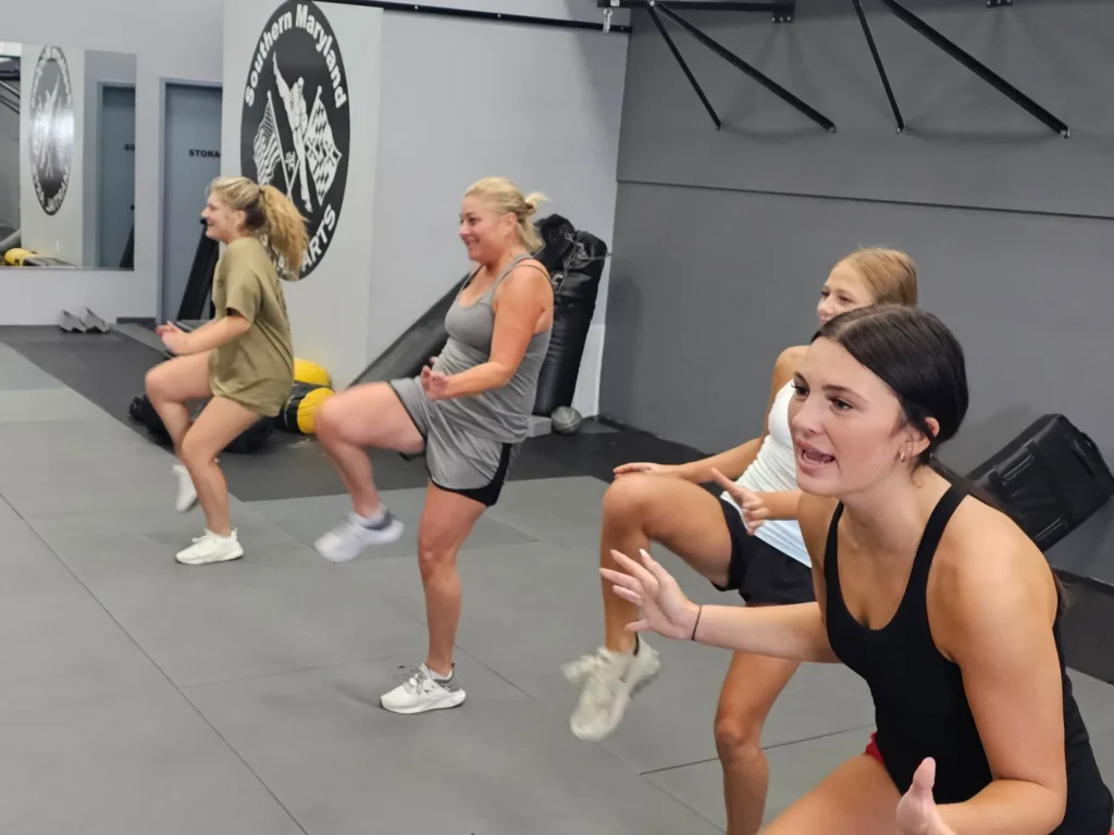 group of women participating in Krav Maga fitness drills, working on strength and defense techniques at Guardian Krav Maga LLC
