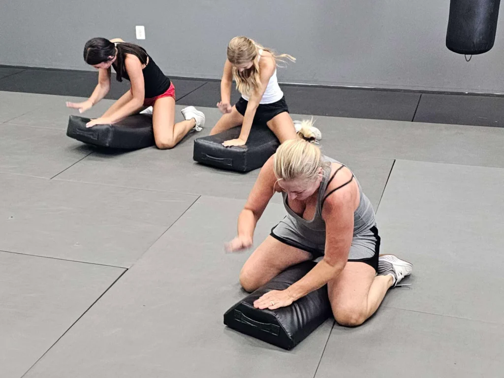 Krav Maga training session with a focus on defense against physical attacks. Guardian Krav Maga LLC offers comprehensive self-defense courses for women.