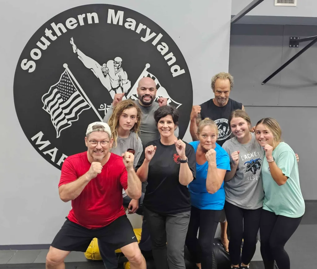 Guardian Krav maga LLC , Krav Maga Self Defense Training in Southern Maryland, MD Group of people happily posing after a Krav Maga drill session at Guardian Krav Maga LLC successful Training in Southern Maryland